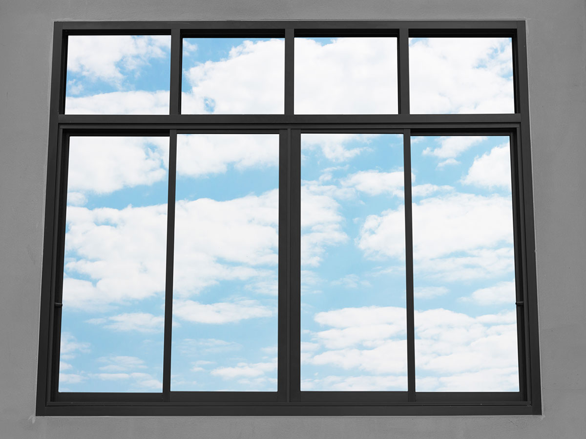 Apartment interior with aluminium framed windows overlooking a city skyline