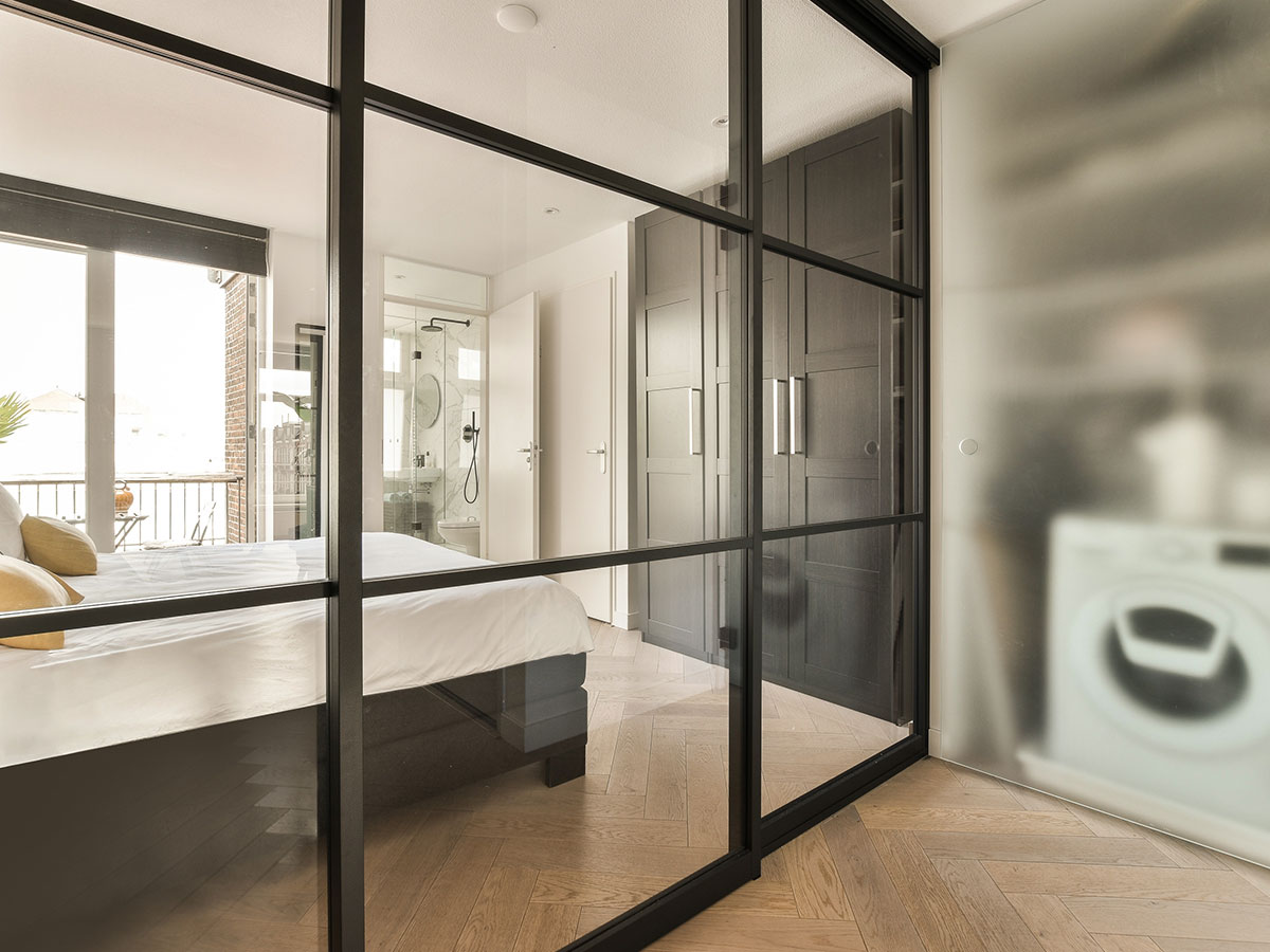 Modern bedroom interior featuring a sliding partition door used to separate living and sleeping areas