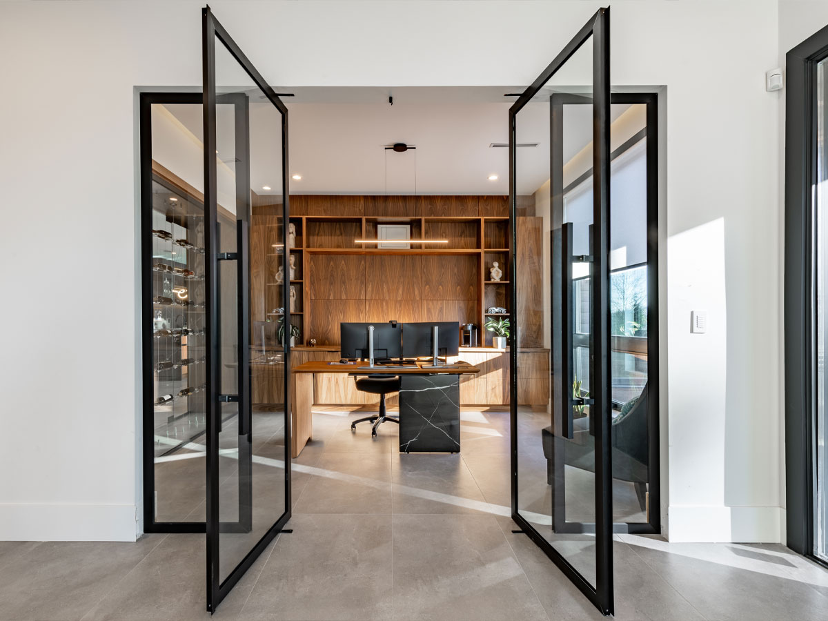 An open glass door leading to a home office