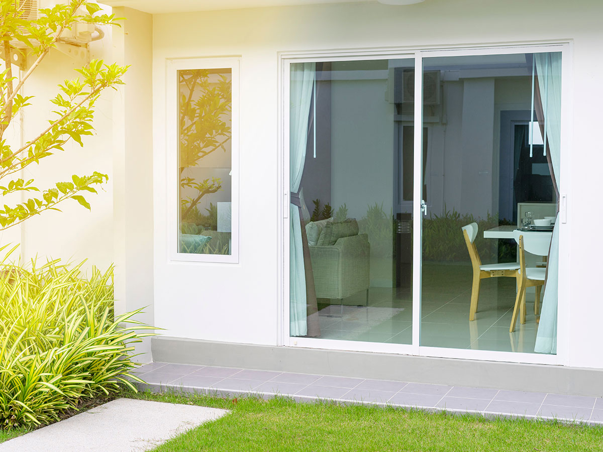 Modern home exterior displaying a sliding glass door